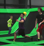 Adult and Child Playing Dodgeball on Trampolines